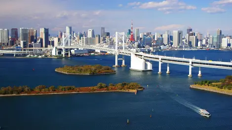 The Rainbow Bridge, white day, multicolored night, is a symbol of Tokyo.